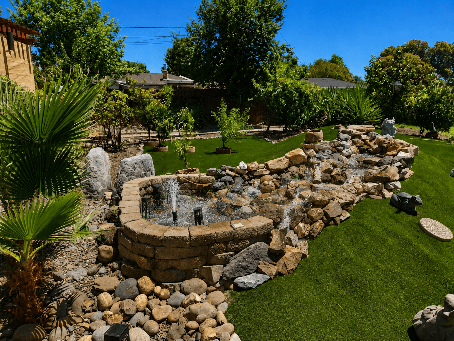 Peaceful backyard garden with rock borders at The Oaks at Garfield