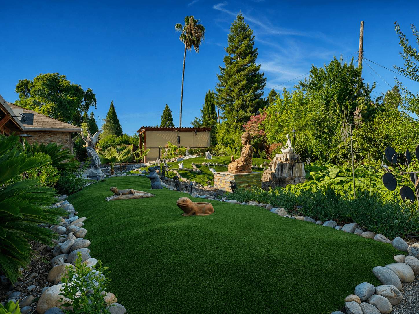 Beautiful backyard garden with statues and lush greenery at The Oaks at Garfield